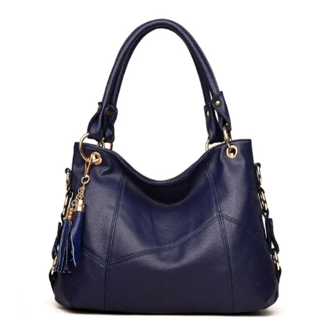 Lux soft leather shoulder bag in navy blue with gold hardware, tassel charm, and chain strap