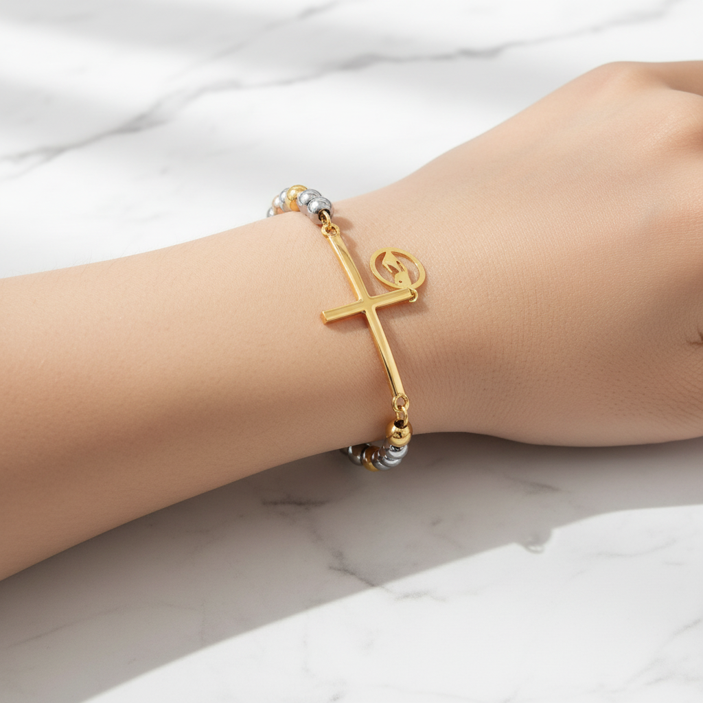 Golden Rose tri-color beaded cross bracelet on wrist - marble background